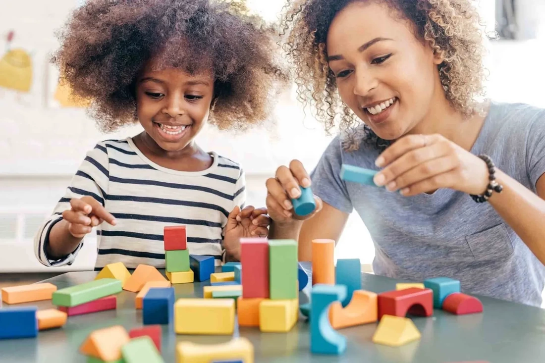 An adult and child enjoying a block-building activity together